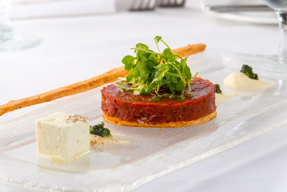 Pascal' on Ponce serves this tomato tatin with sheep milk cheese, mustard , creme fraiche, and garden salad.